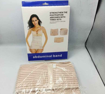 Abdominal band packaging with a woman on it, placed on a white surface.
